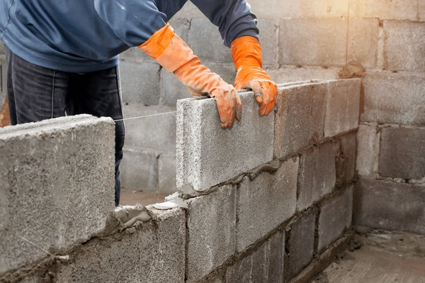 masonry worker make concrete wall 600nw 1824084962